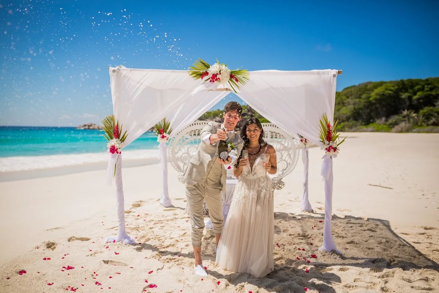 Couple celebrating beach wedding