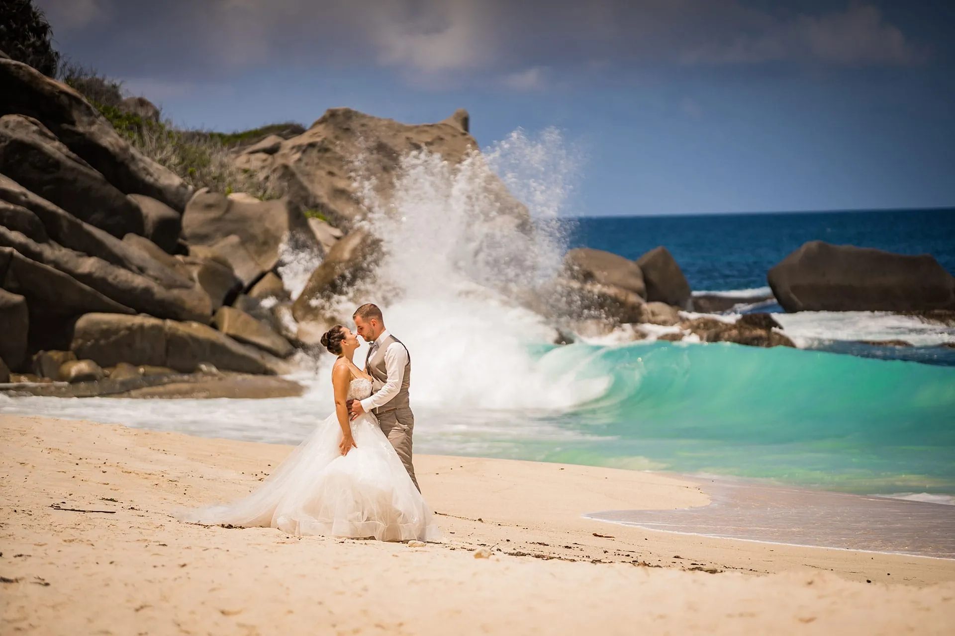 Couple looking each other on beach side in Seychelles