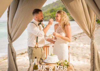 Jennifer Daniel feeding each other wedding cake