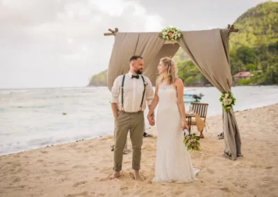 Jennifer Daniel standing at the wedding entrance on the beach