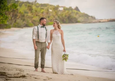 Jennifer Daniel posing for wedding photos on the beach